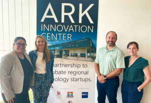 A group picture of Sierra Perez, Becca Brown, Taylor Johnston and Elizabeth Nelson with a sign for ARK Innovation Center