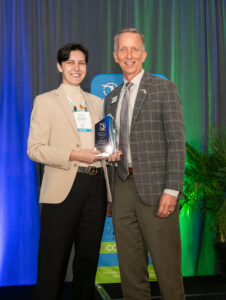 Abigail Wagner accepts the Dan Webster Award from Paul Sohl.